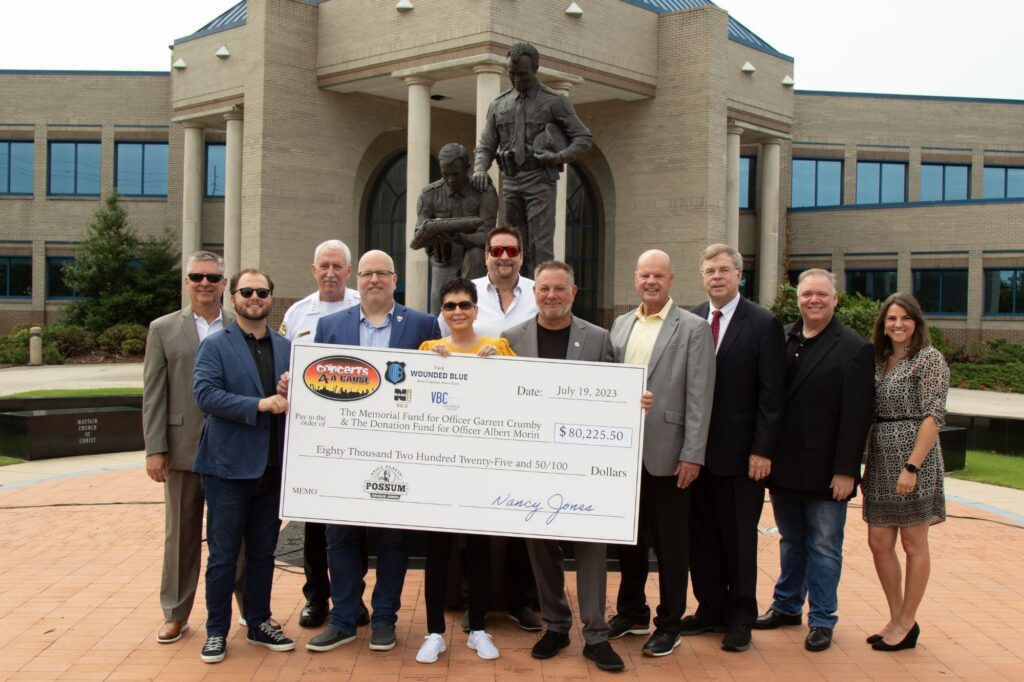 Nancy Jones presenting fundraising check to Huntsville Police Department