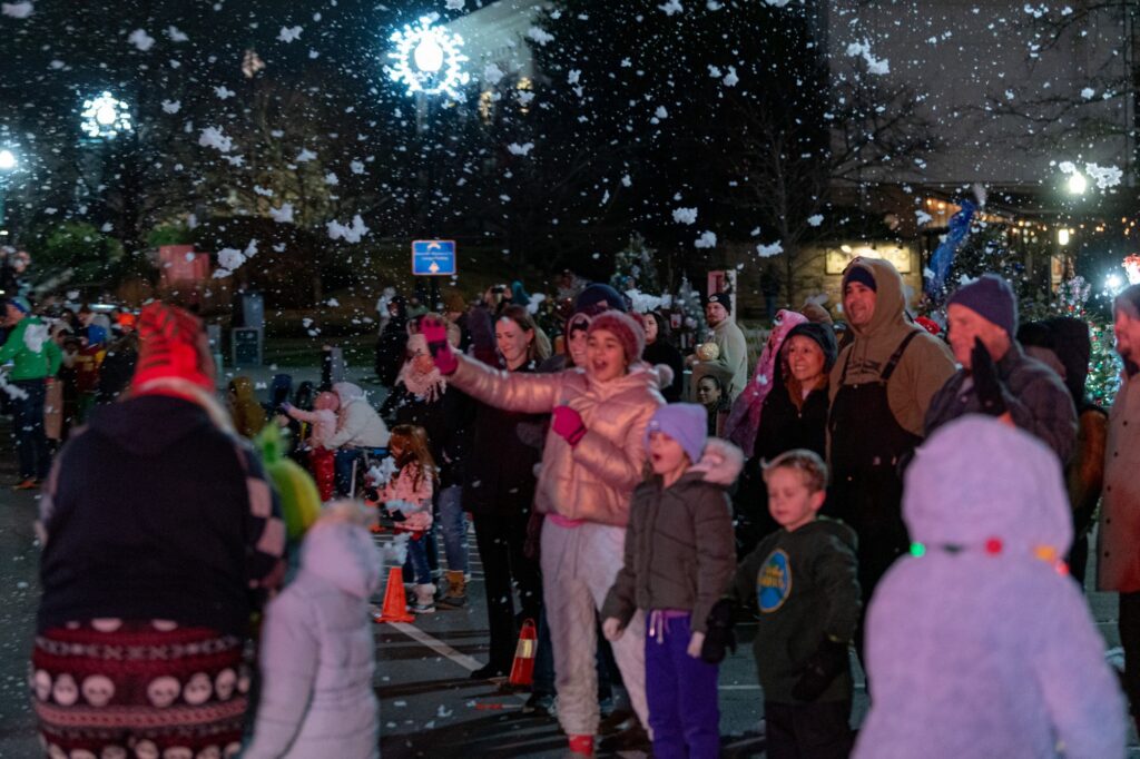 Photo of crowd at Christmas Parade in snow from passing snow machine