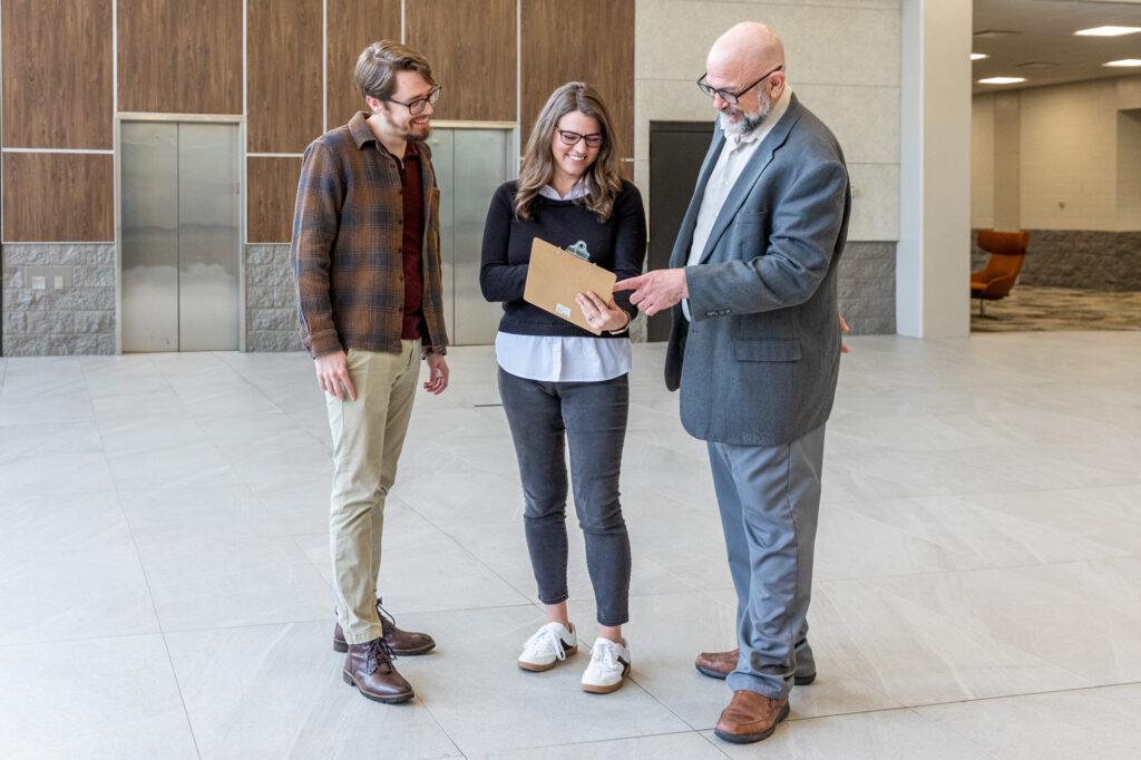 Image of conference guests discussing notes