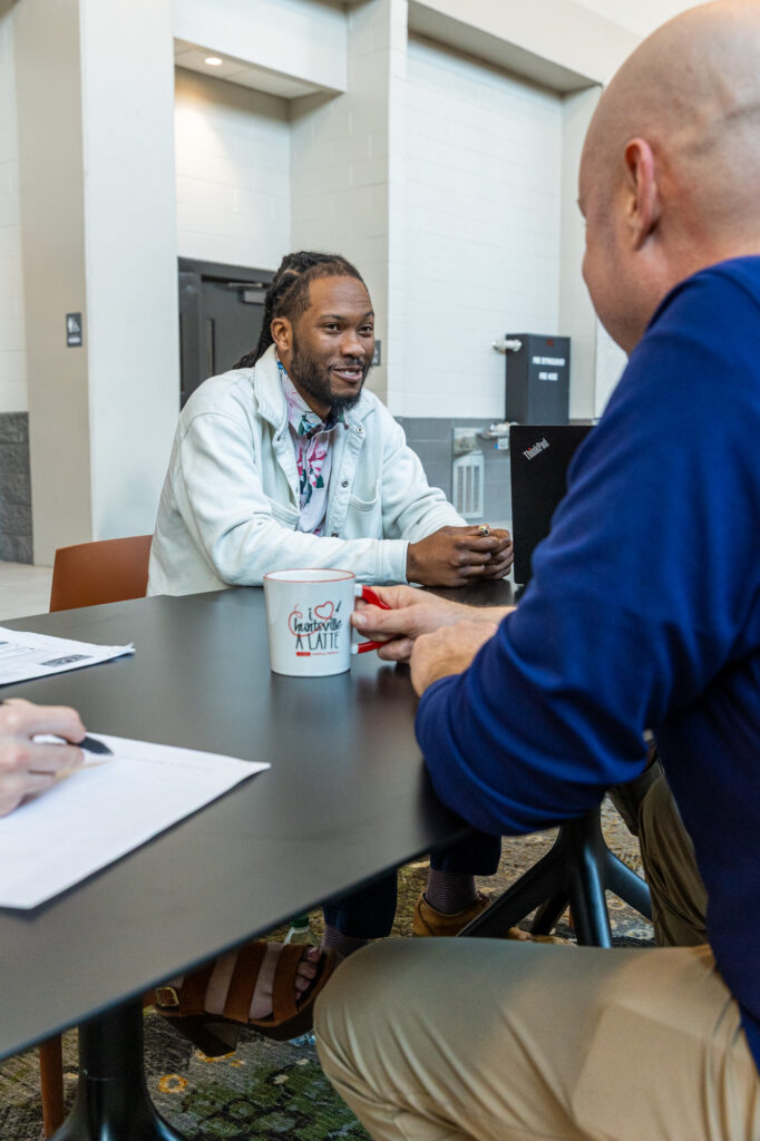 Photo of meeting attendees gathered around a table