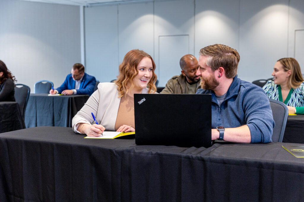 Photo of conference attendees sitting in lecture in Saturn Salon