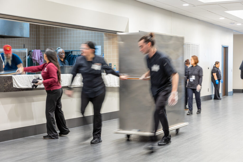 Photo of catering servers preparing a banquet in Saturn Gallery