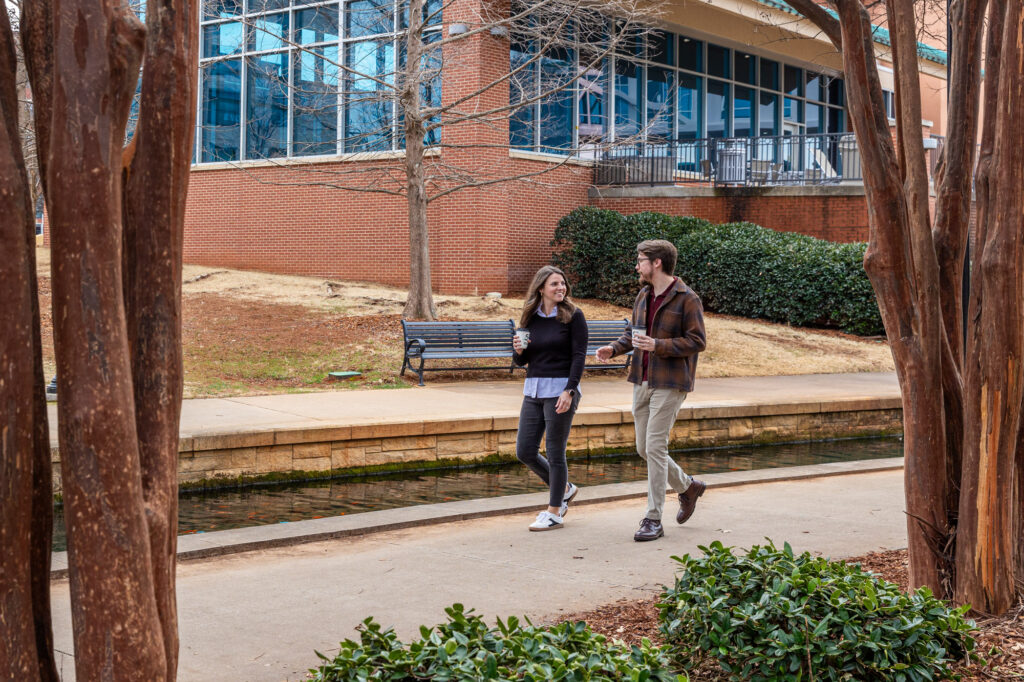Image of two event attendees enjoying coffee at Big Spring Park