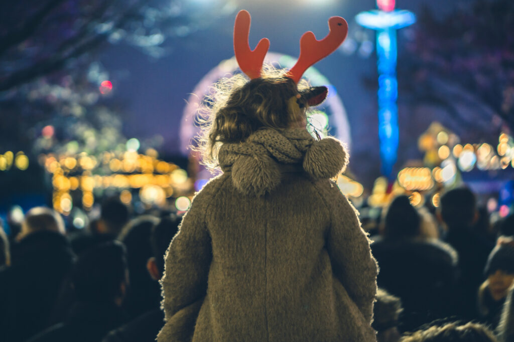 Image of girl wearing reindeer headband at the Christmas Parade
