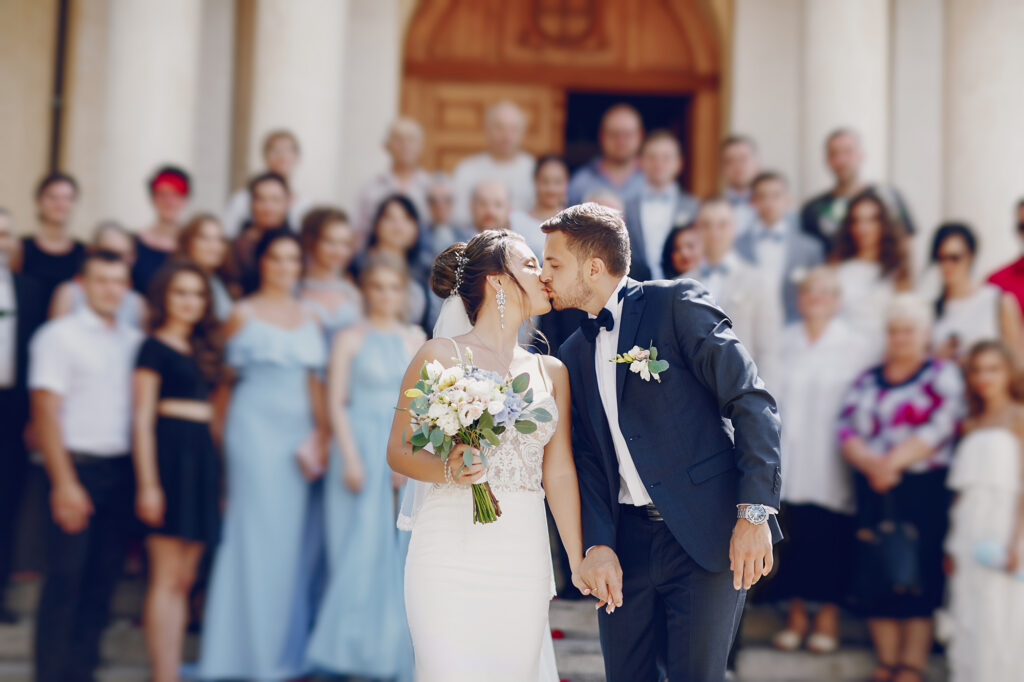 Image of a bride and groom sharing their first kiss