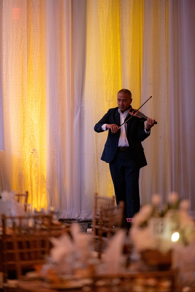 Photo of violinist performing in reception at VBC Saturn Ballroom
