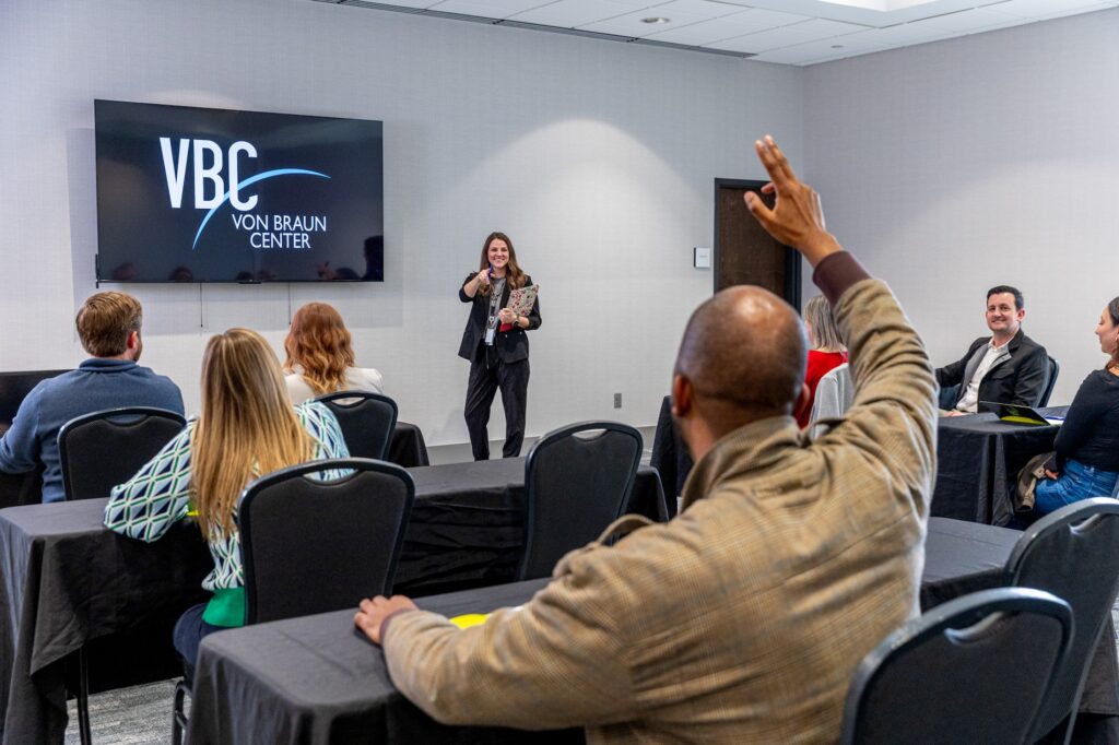 Photo of conference attendees listening to a lecture in VBC Saturn Salon