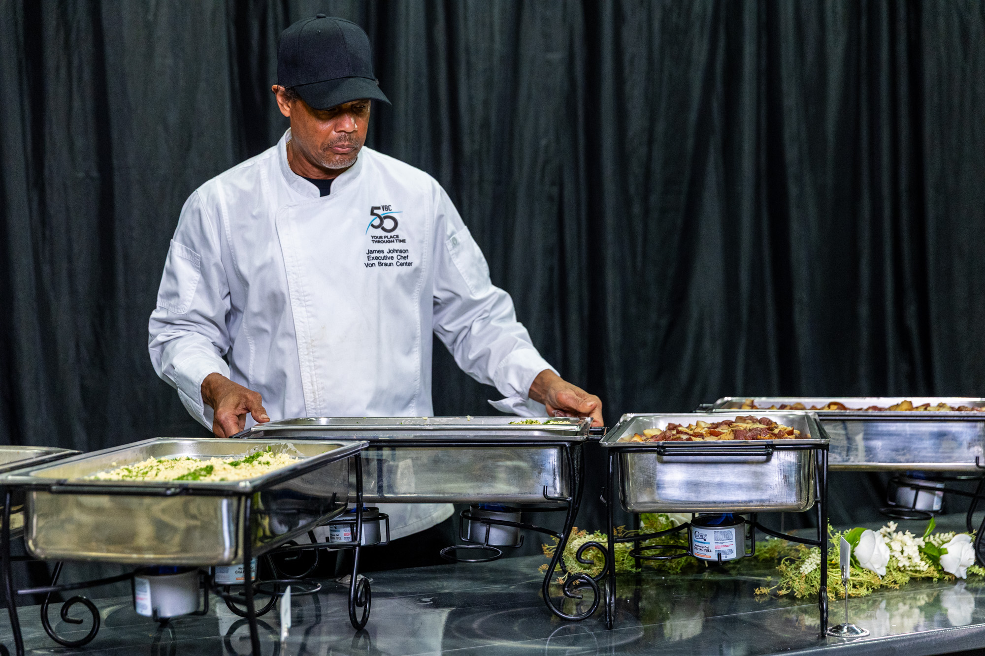 Photo of chef adding dishes to a buffet