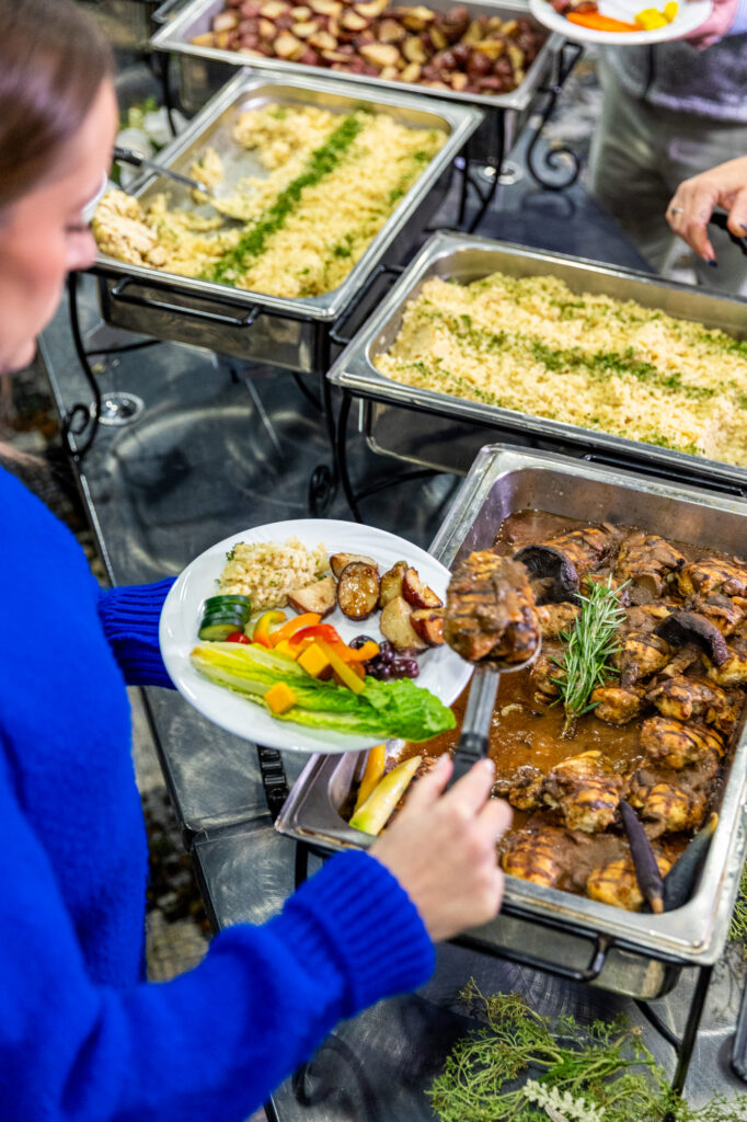 Photo of guest making their plate at a VBC buffet