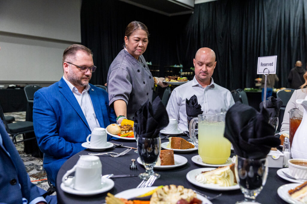 Photo of guests being served a seated meal in VBC East Hall