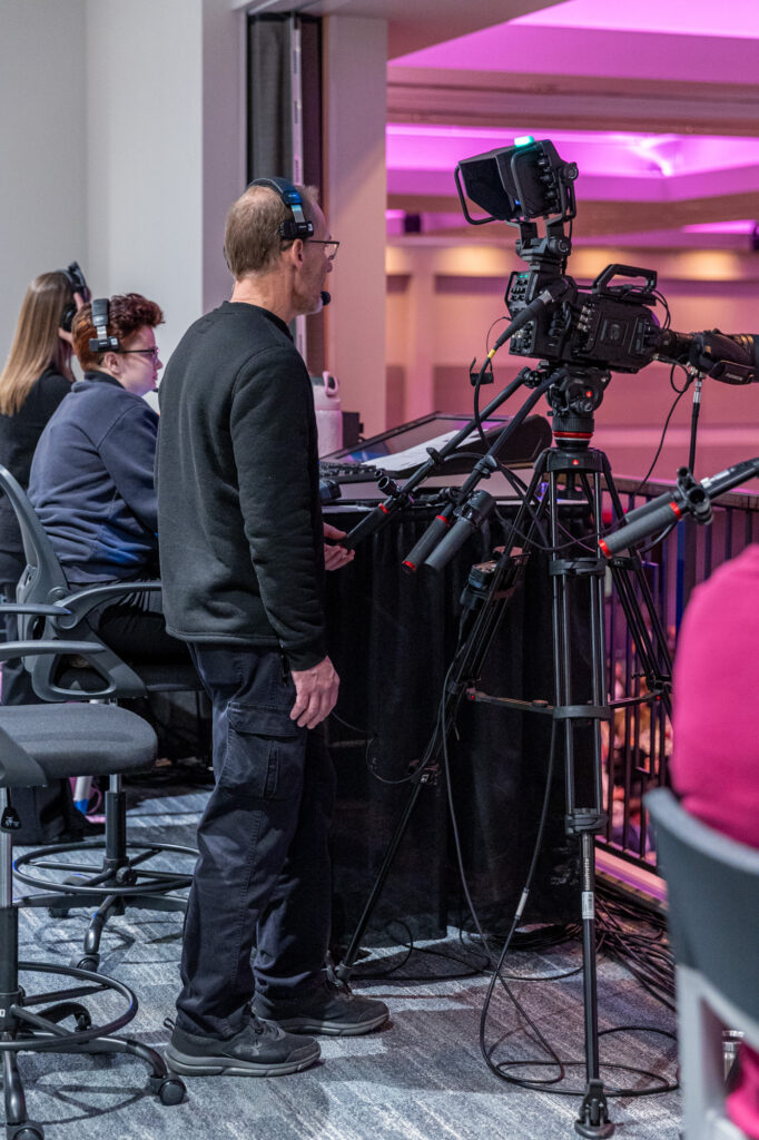 Photo of a cameraman recording footage in Saturn Ballroom