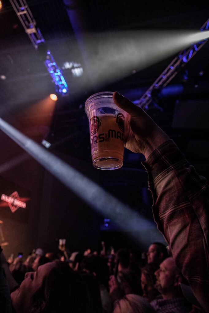 Photo of Mars Music Hall cup being raised in the air during a show in Mars