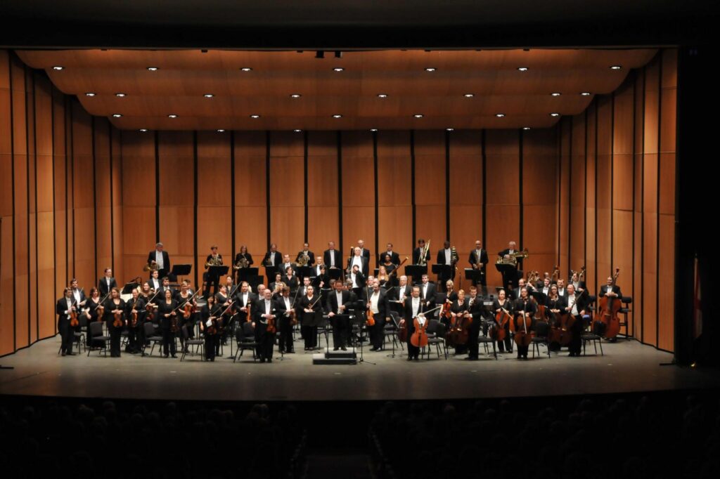 Photo of the HSO onstage in the VBC Mark C. Smith Concert Hall