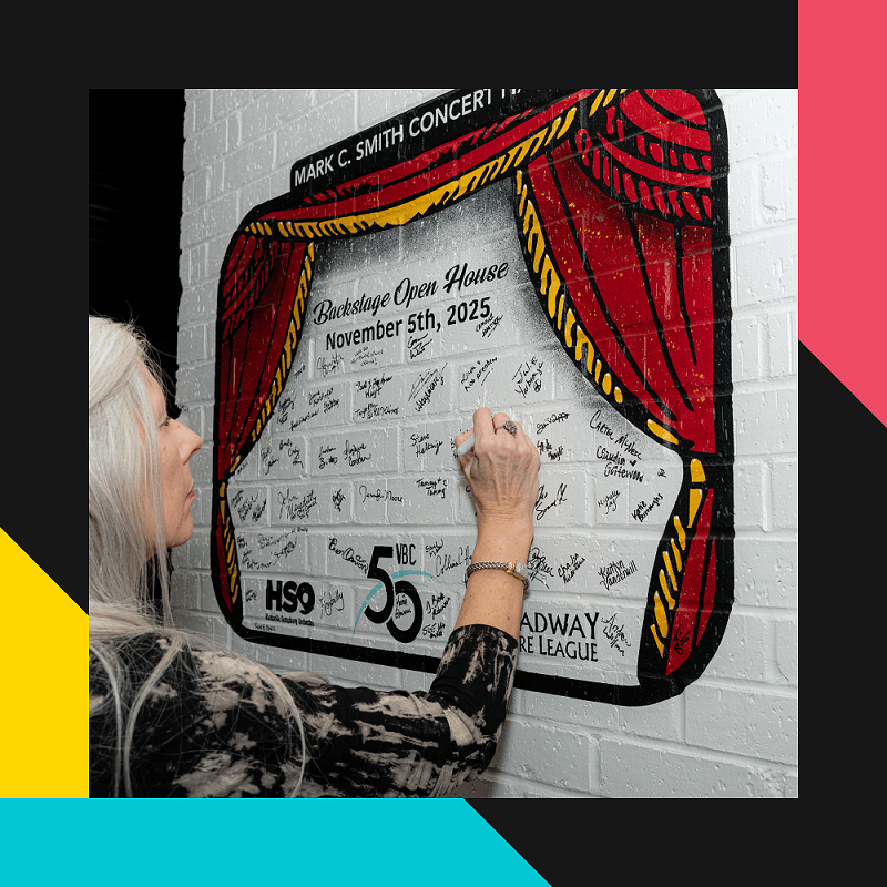 Photo of guest signing mural at Concert Hall backstage open house following expansion project