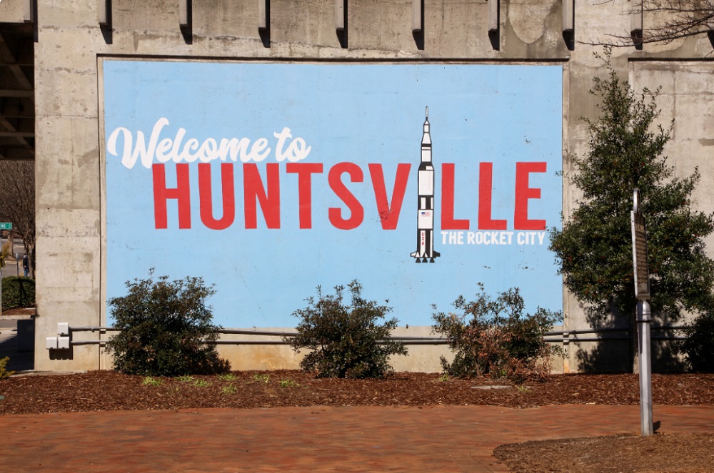 Photo of mural downtown that looks like a postcard reading Welcome to Huntsville