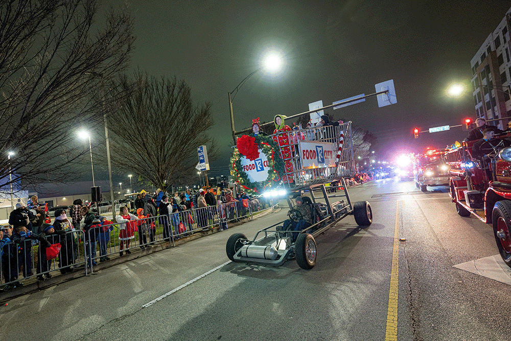 Food City leading the 2025 Huntsville Christmas Parade with their giant decorated shopping cart